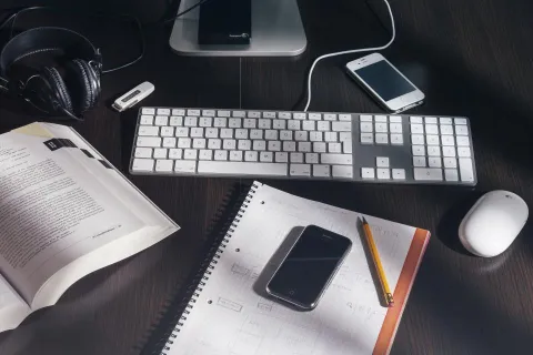 A modern Android smartphone resting on a clean wooden desk.
