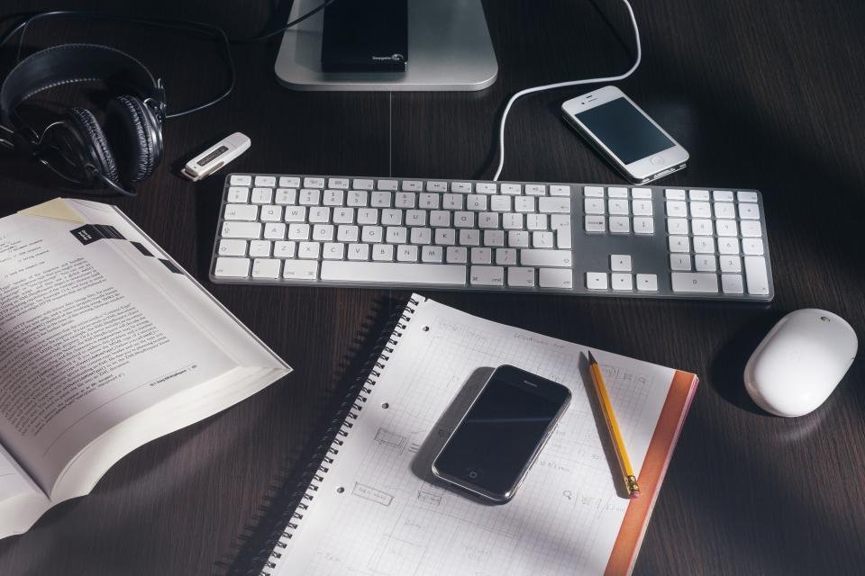 A modern Android smartphone resting on a clean wooden desk.