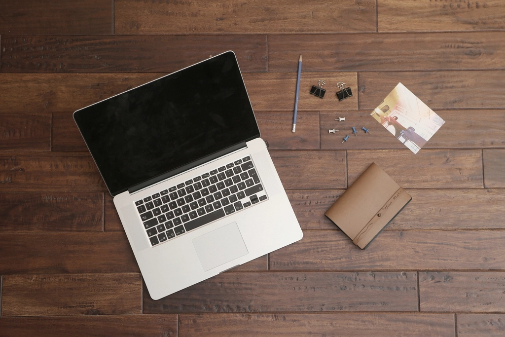 Desk setup with laptop and notepad for productivity