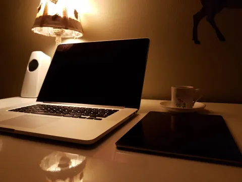 A professional workspace with a laptop and coffee, representing modern productivity.