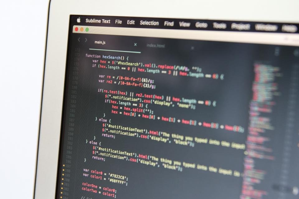 Laptop screens displaying artificial intelligence interfaces side by side