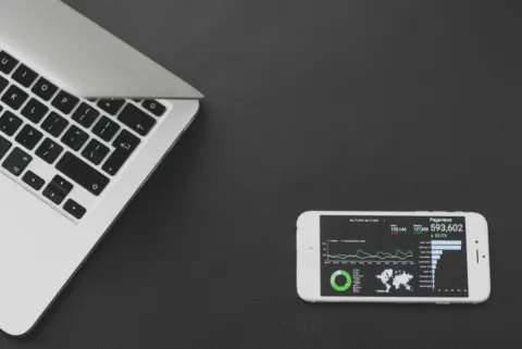 Laptop displaying AI assistant comparison on a clean desk.