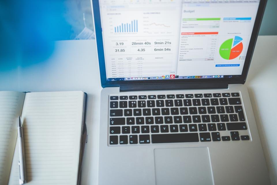 مكتب عمل حديث يحتوي على حاسوب محمول وأدوات مكتبية لمقارنة برامج الإنتاجية