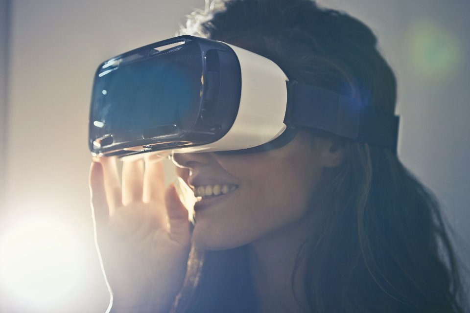 A Meta Quest VR headset and a smartphone on a desk illustrating the account setup process.