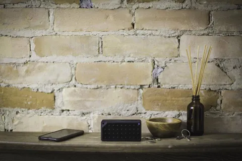 Cleaning an Android phone speaker grille with a soft brush.