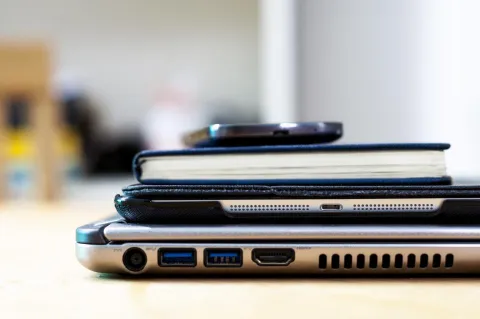 An iPad resting on a wooden desk with soft lighting.