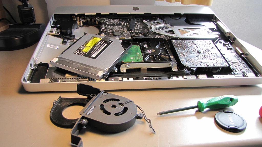 A technician working on computer internal hardware components.