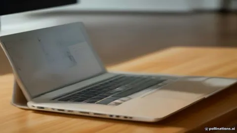 Laptop displaying audio settings with external desktop speakers