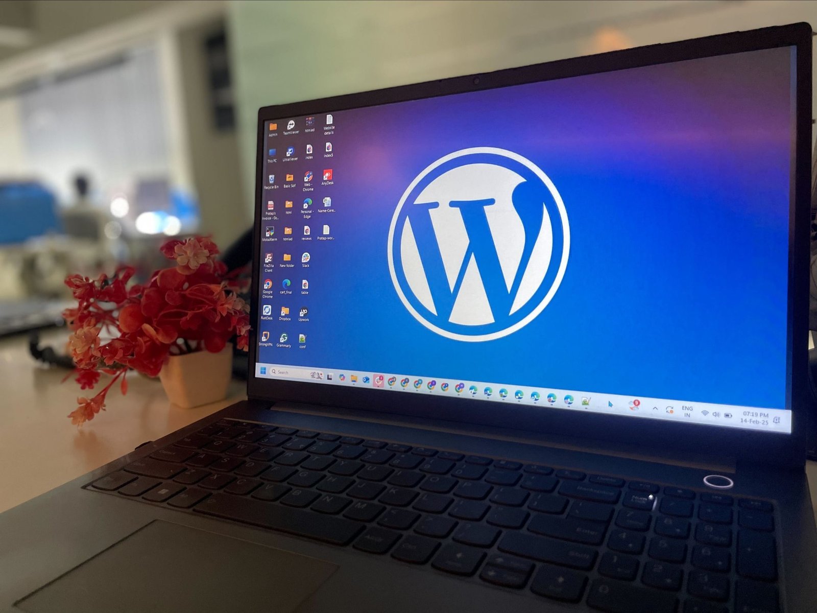 Laptop showing two web browsers open side by side on a wooden desk.