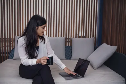 A laptop open on a modern desk displaying an AI productivity application interface.