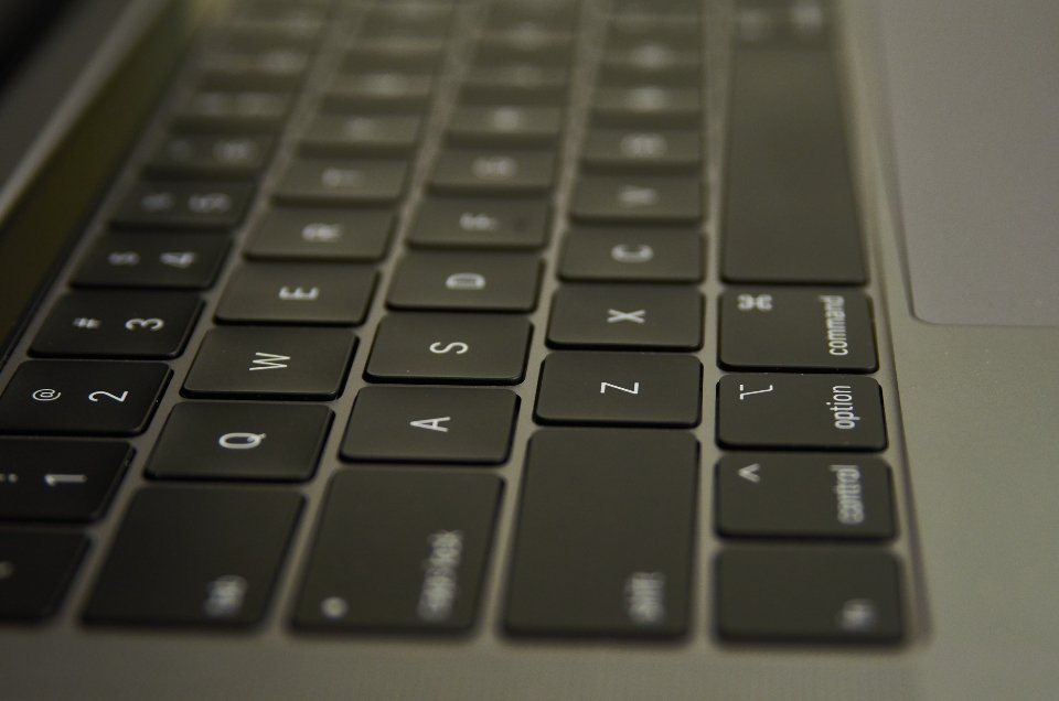 Modern Windows laptop on a wooden desk showing an active screen.