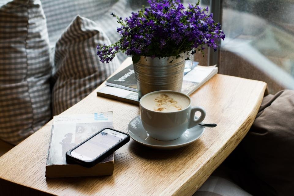 An iPhone sitting on a wooden surface showing notification settings.