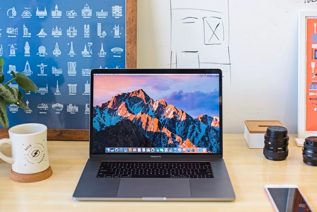 A MacBook laptop resting on a desk in a clean office environment