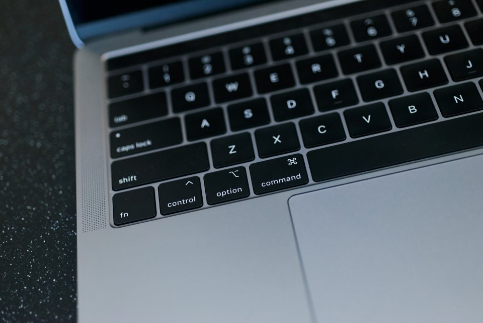 A modern desk workspace with a laptop and documents.