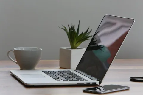 A modern laptop on a desk showing a professional word processing application.