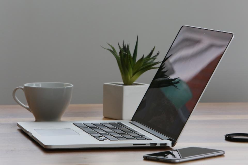 A modern laptop on a desk showing a professional word processing application.