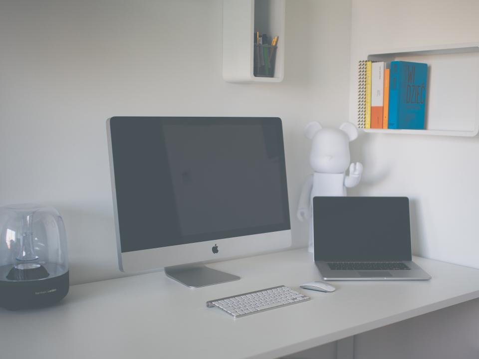 A modern desk setup showing a desktop PC and a laptop side by side.