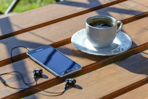 Close-up of a smartphone being cleaned for speaker troubleshooting