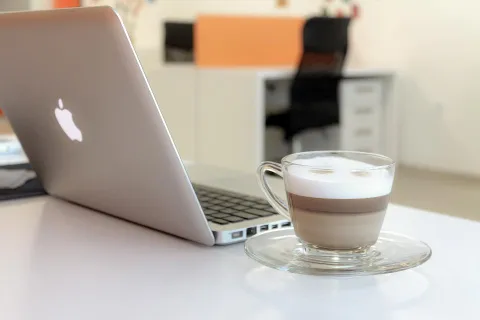 Modern workspace setup with a laptop showing productivity applications