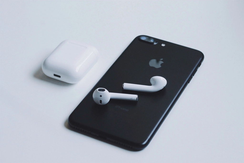 AirPods 4 wireless earbuds and charging case on a desk