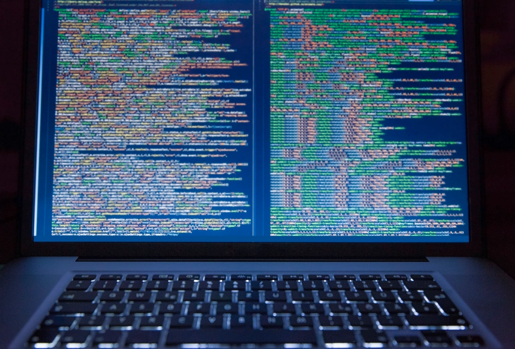 A computer screen showing email application troubleshooting steps on a clean desk.