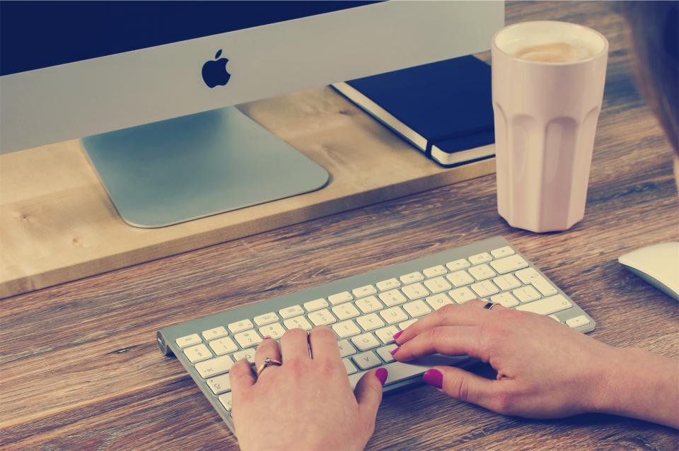 A modern computer desktop setup on a clean wooden desk.