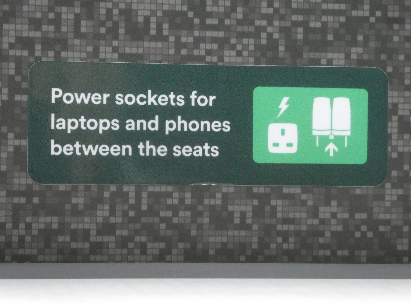 Person pressing the power button on a Windows laptop connected to a charger
